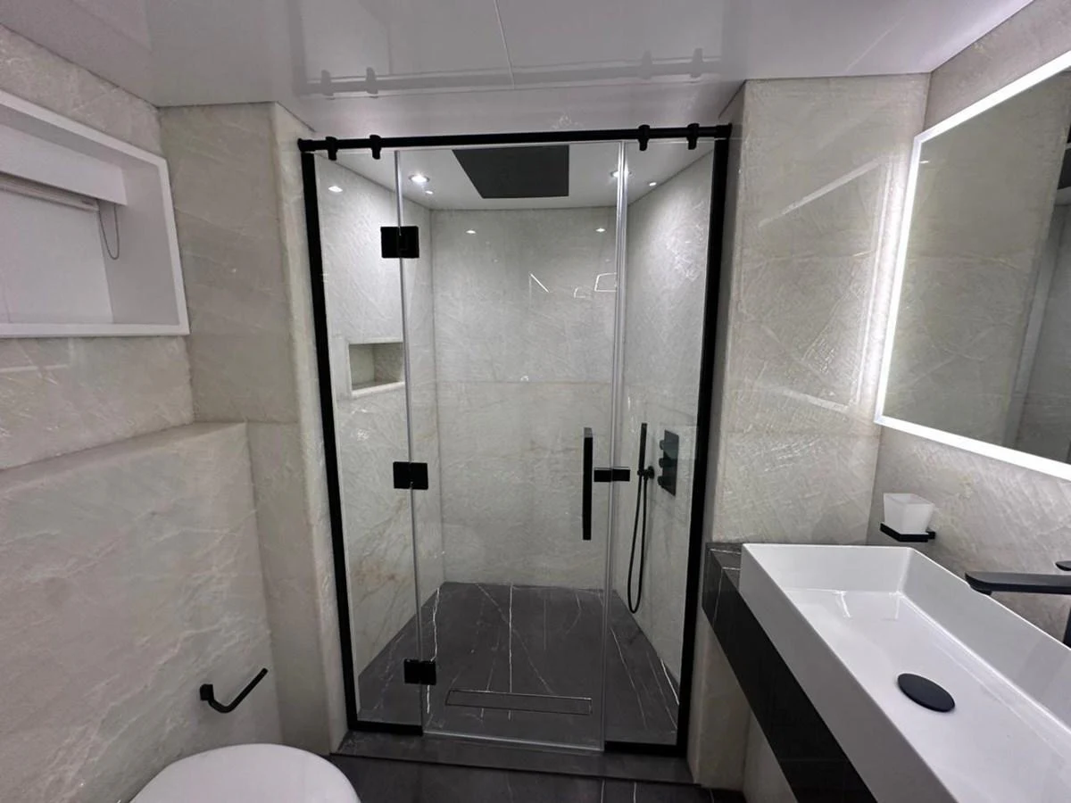 a bathroom with a shower unit and sink aboard XCEL 70 Yacht for Sale