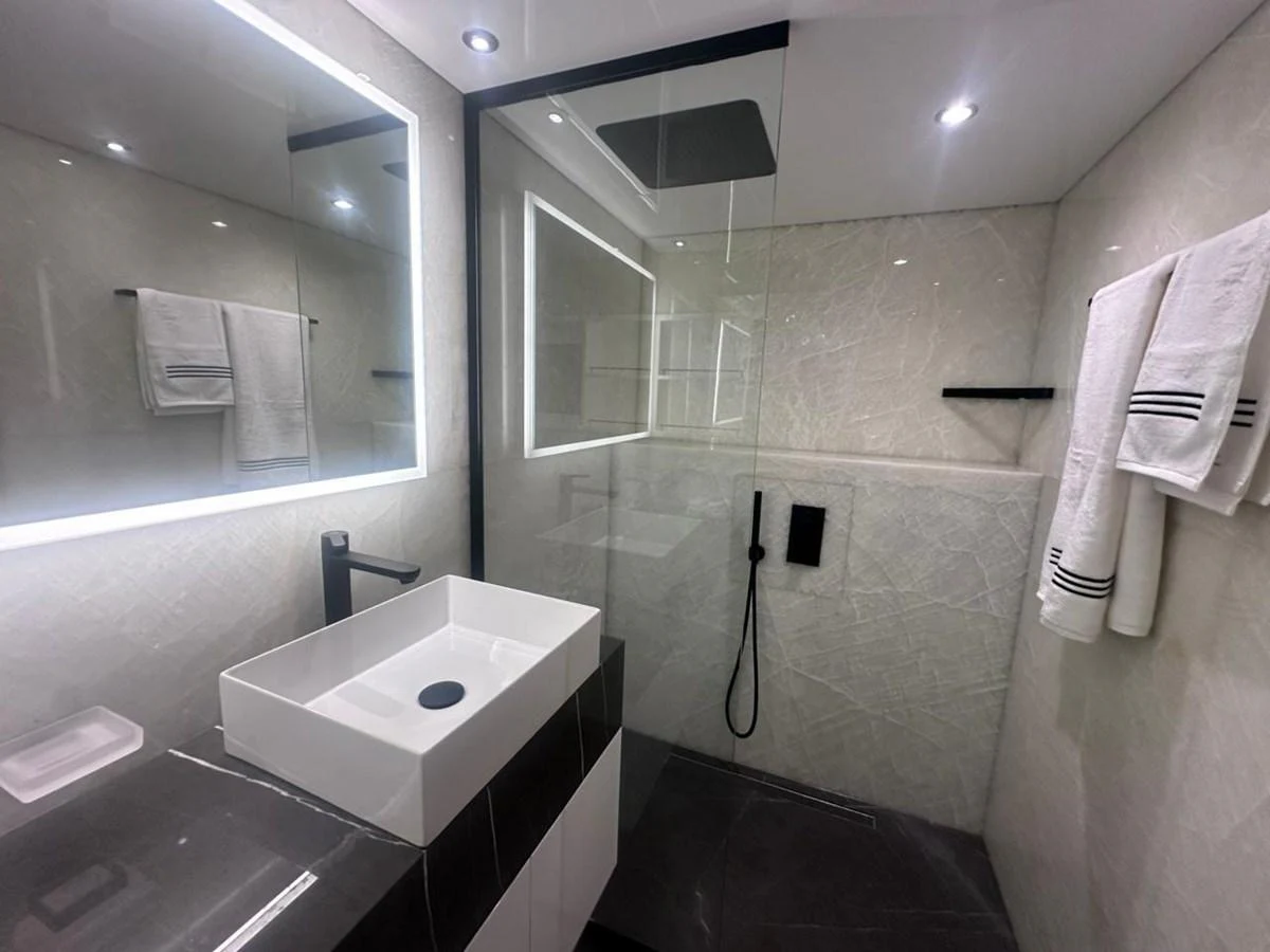 a bathroom with a sink and mirror aboard XCEL 70 Yacht for Sale