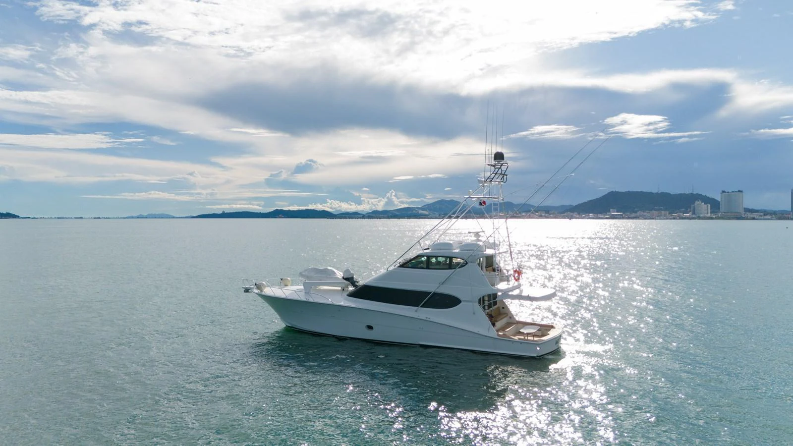 A sleek yacht glides gracefully on calm waters under a bright sky. aboard VIDA 1 Yacht for Sale