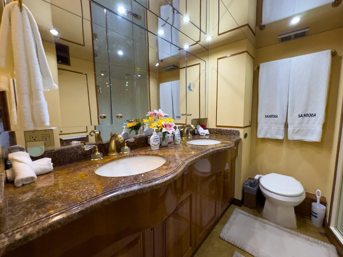 The yacht's bathroom features elegant fixtures and a luxurious countertop with dual sinks. aboard VIDA 1 Yacht for Sale