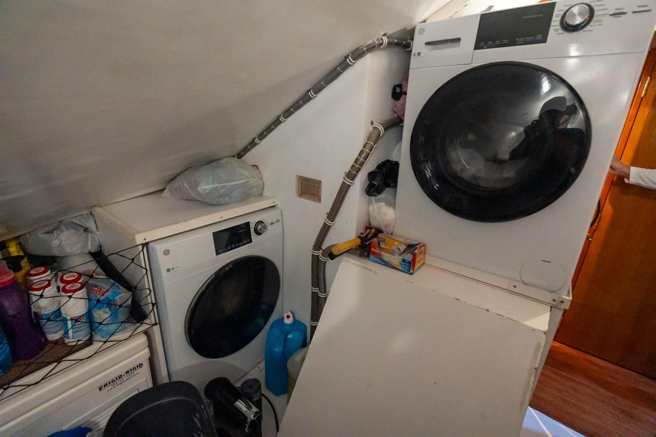 The yacht's laundry room is equipped with modern washing and drying machines, ensuring convenience for extended voyages. aboard VIDA 1 Yacht for Sale