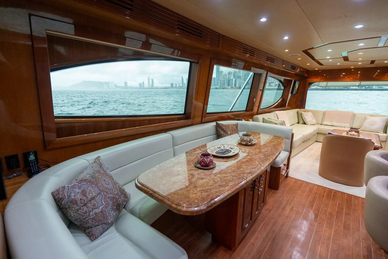 The yacht's salon features luxurious seating with panoramic windows offering stunning ocean views. aboard VIDA 1 Yacht for Sale