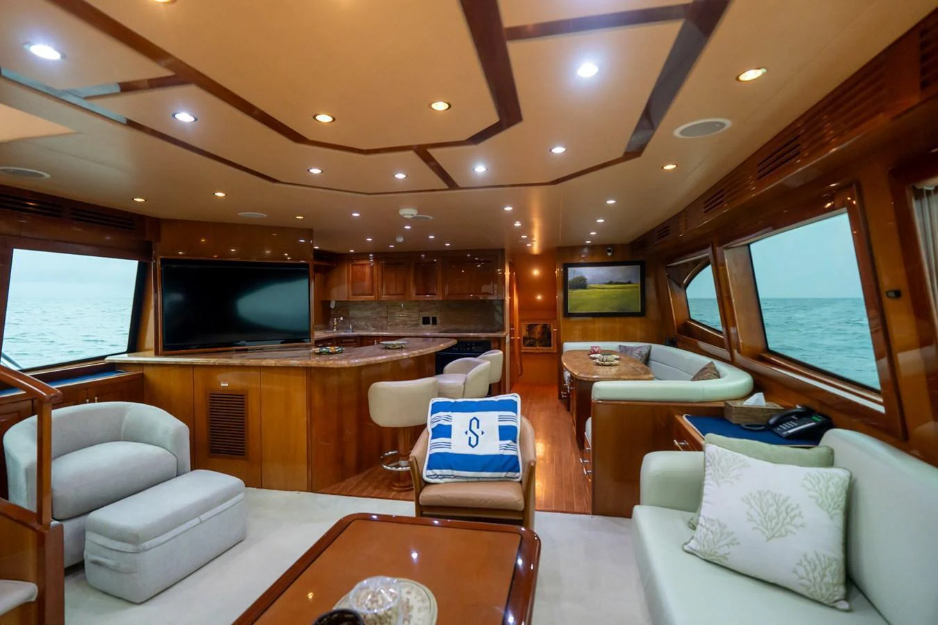 The yacht's salon features luxurious seating, a large TV, and elegant wooden finishes. aboard VIDA 1 Yacht for Sale