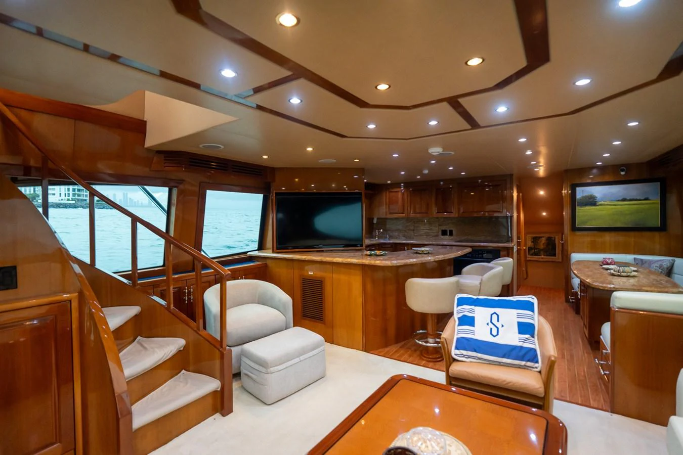 The salon features luxurious seating, a flat-screen TV, and elegant wooden finishes. aboard VIDA 1 Yacht for Sale