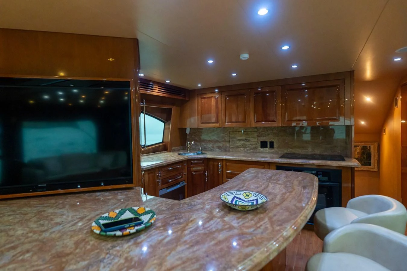 The yacht's galley features a spacious countertop with modern appliances and elegant lighting. aboard VIDA 1 Yacht for Sale