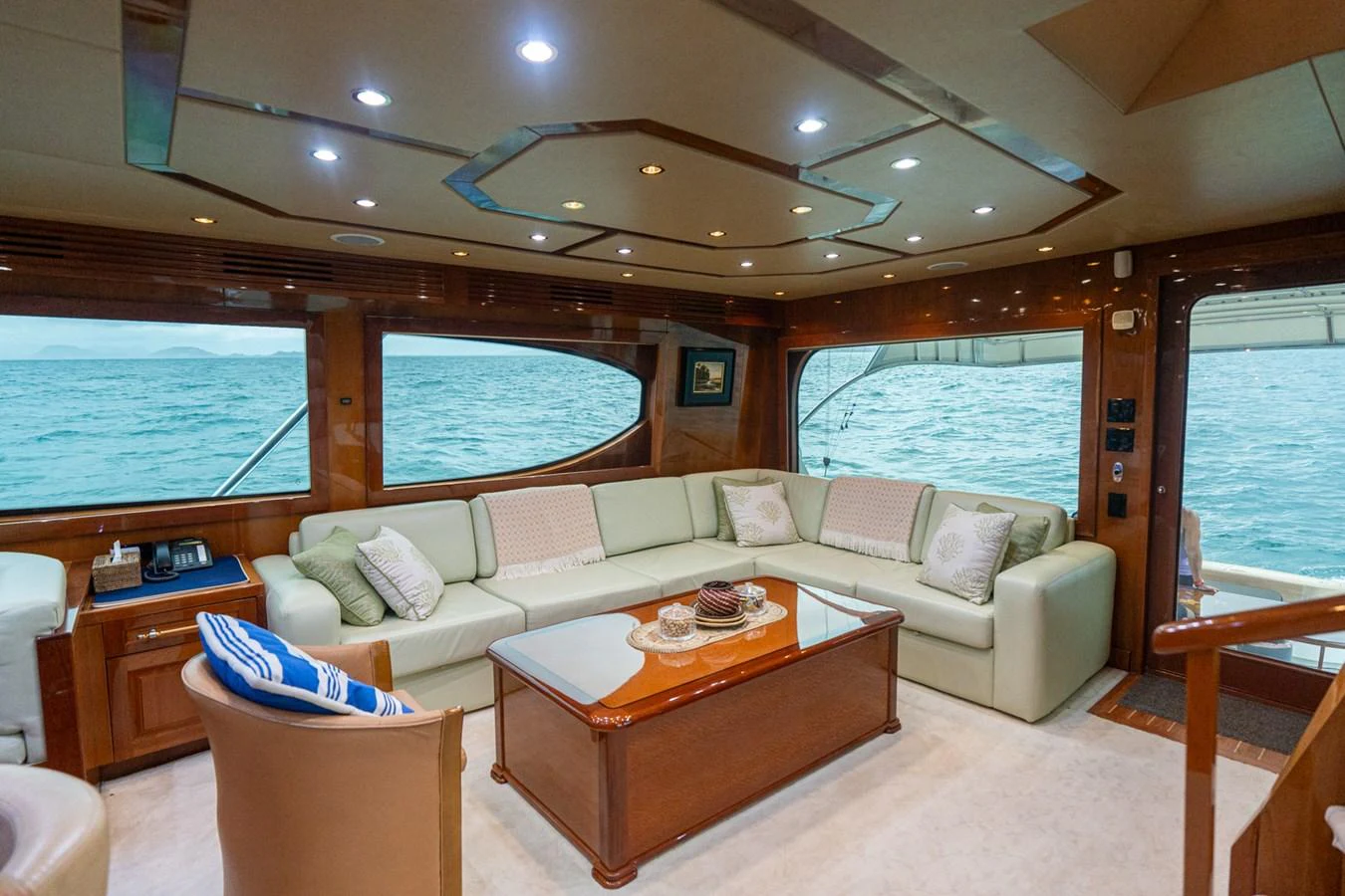 The yacht's salon features a spacious seating area with large windows offering stunning ocean views. aboard VIDA 1 Yacht for Sale