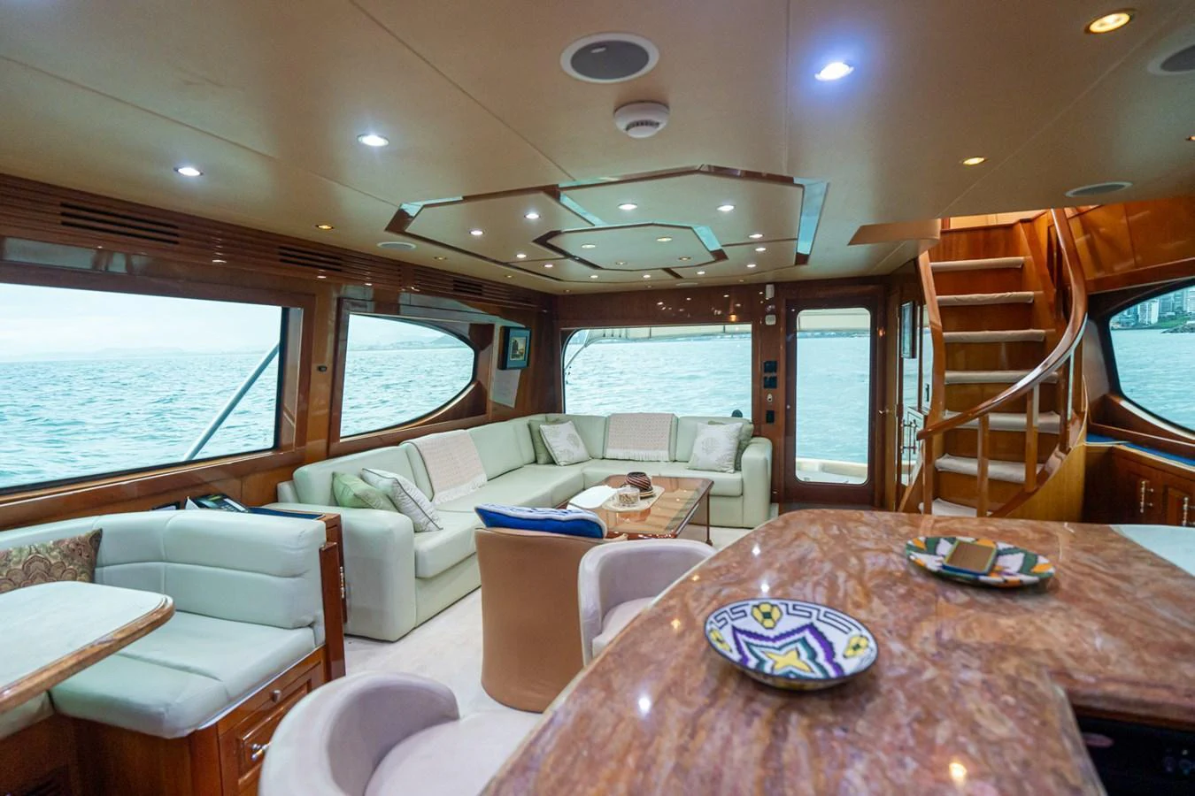 The salon features plush seating, a polished wooden table, and large windows offering stunning sea views. aboard VIDA 1 Yacht for Sale