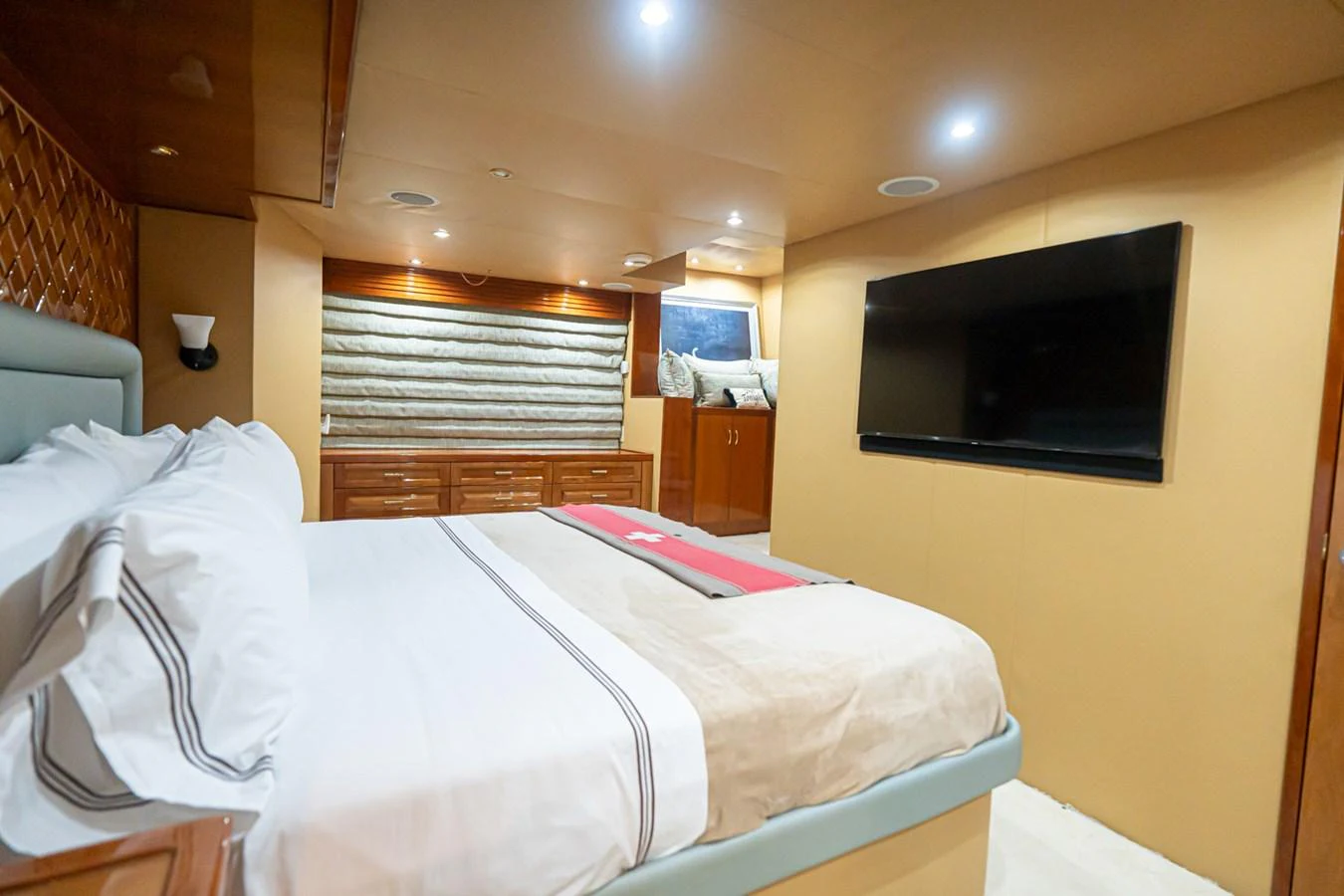 A luxurious stateroom featuring a large bed, ample storage, and a flat-screen TV. aboard VIDA 1 Yacht for Sale