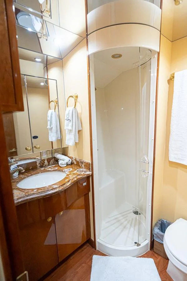 The yacht's bathroom features a compact shower, elegant vanity, and luxurious finishes. aboard VIDA 1 Yacht for Sale