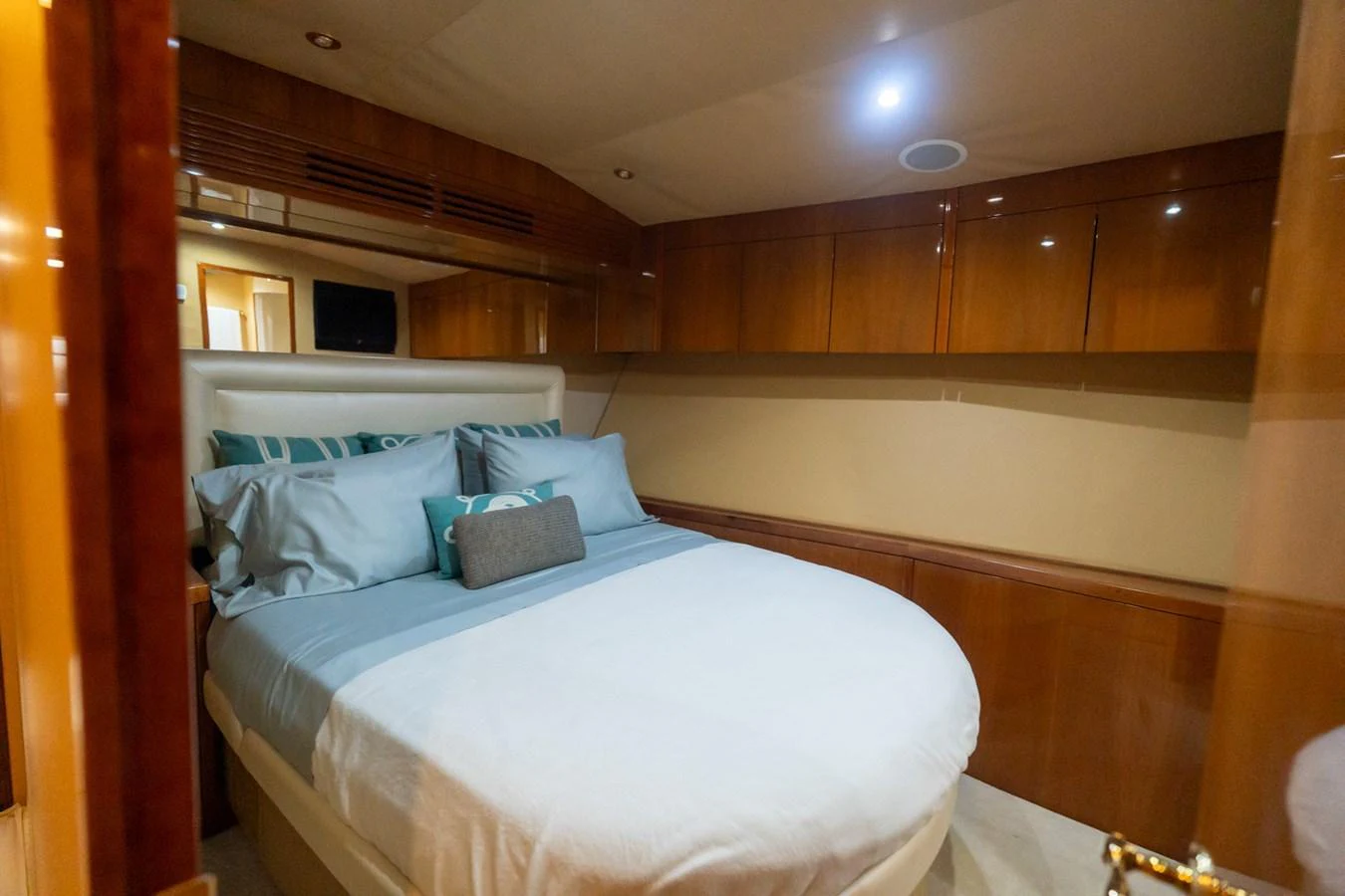 A cozy stateroom with a comfortable bed and elegant wood paneling. aboard VIDA 1 Yacht for Sale