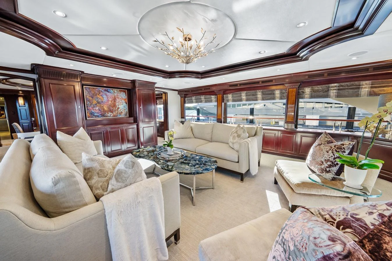 a living room with a large chandelier aboard NICOLE EVELYN Yacht for Sale