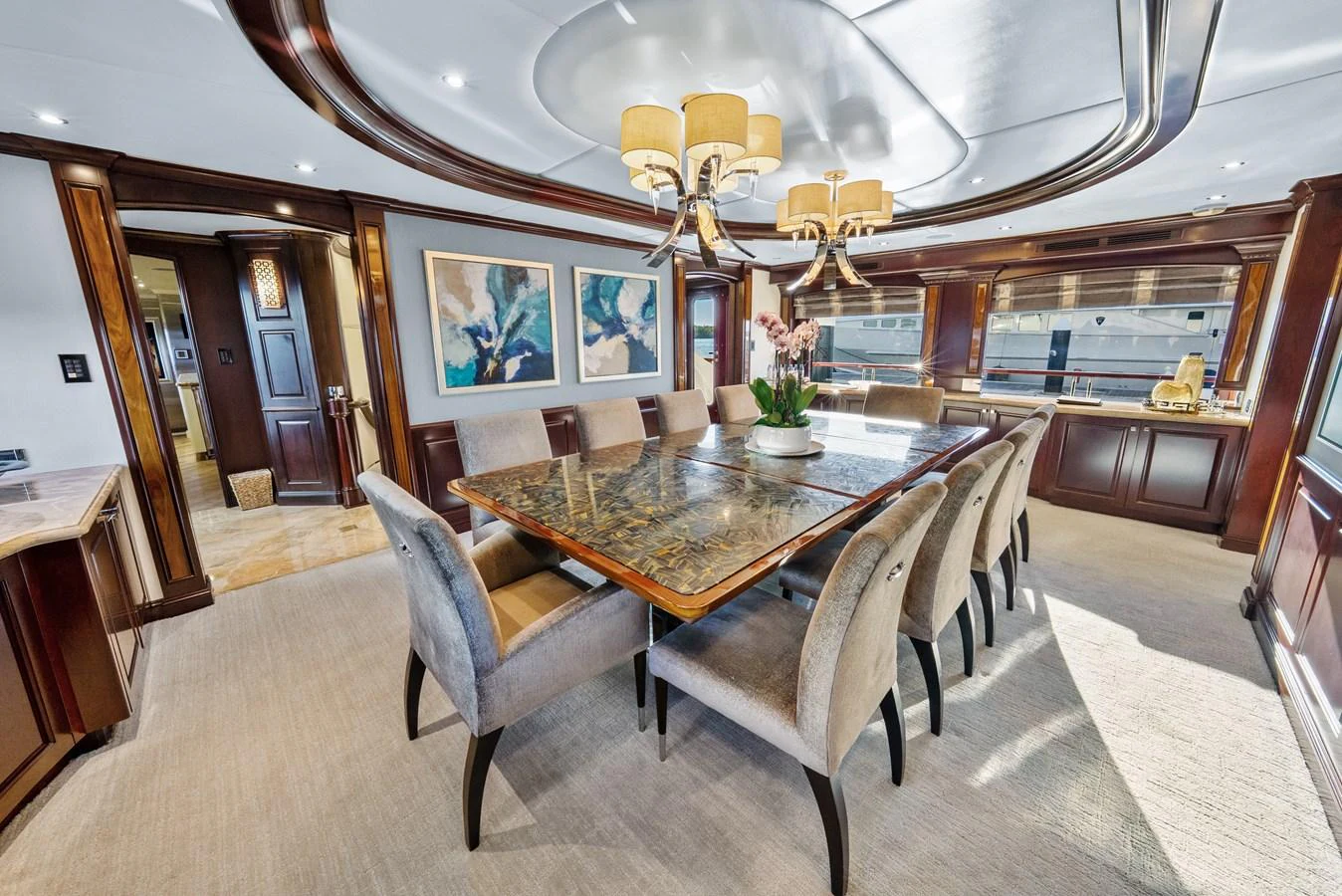 a dining room with a chandelier aboard NICOLE EVELYN Yacht for Sale