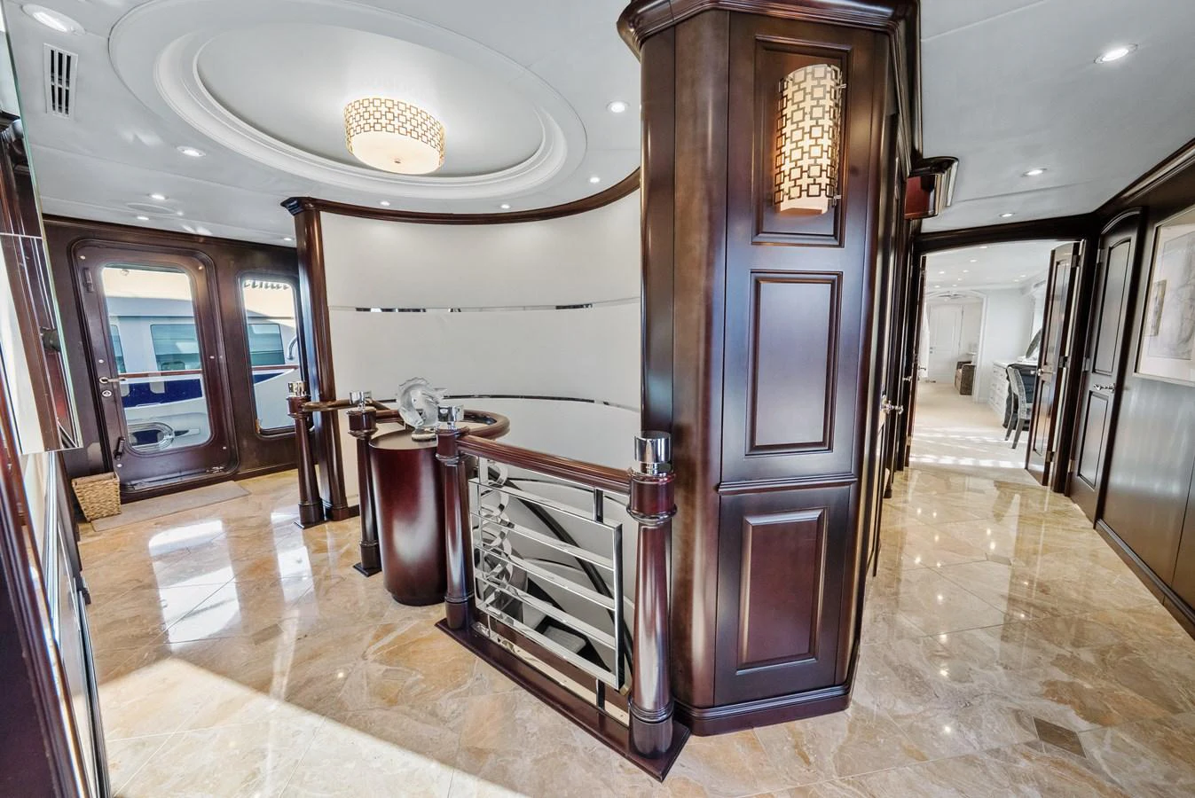 a large room with a large wood door and a chandelier aboard NICOLE EVELYN Yacht for Sale