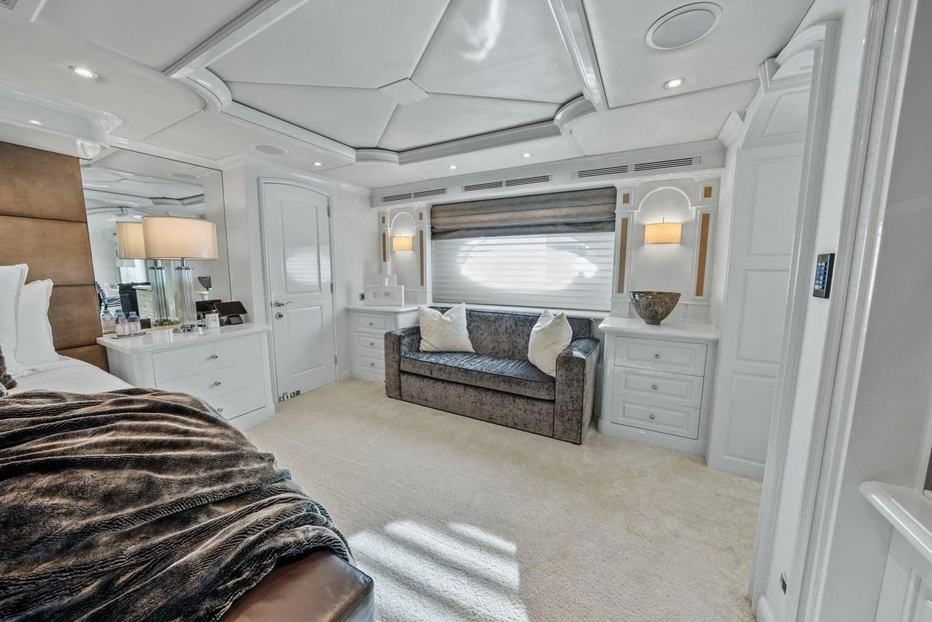 a bedroom with a bed and a couch aboard NICOLE EVELYN Yacht for Sale