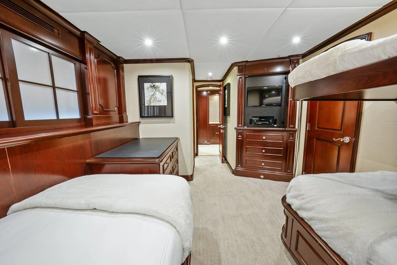 a room with a bed and a desk aboard NICOLE EVELYN Yacht for Sale