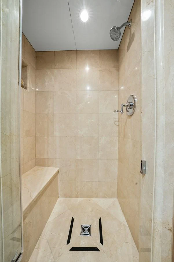 a bathroom with a shower and a sink aboard NICOLE EVELYN Yacht for Sale