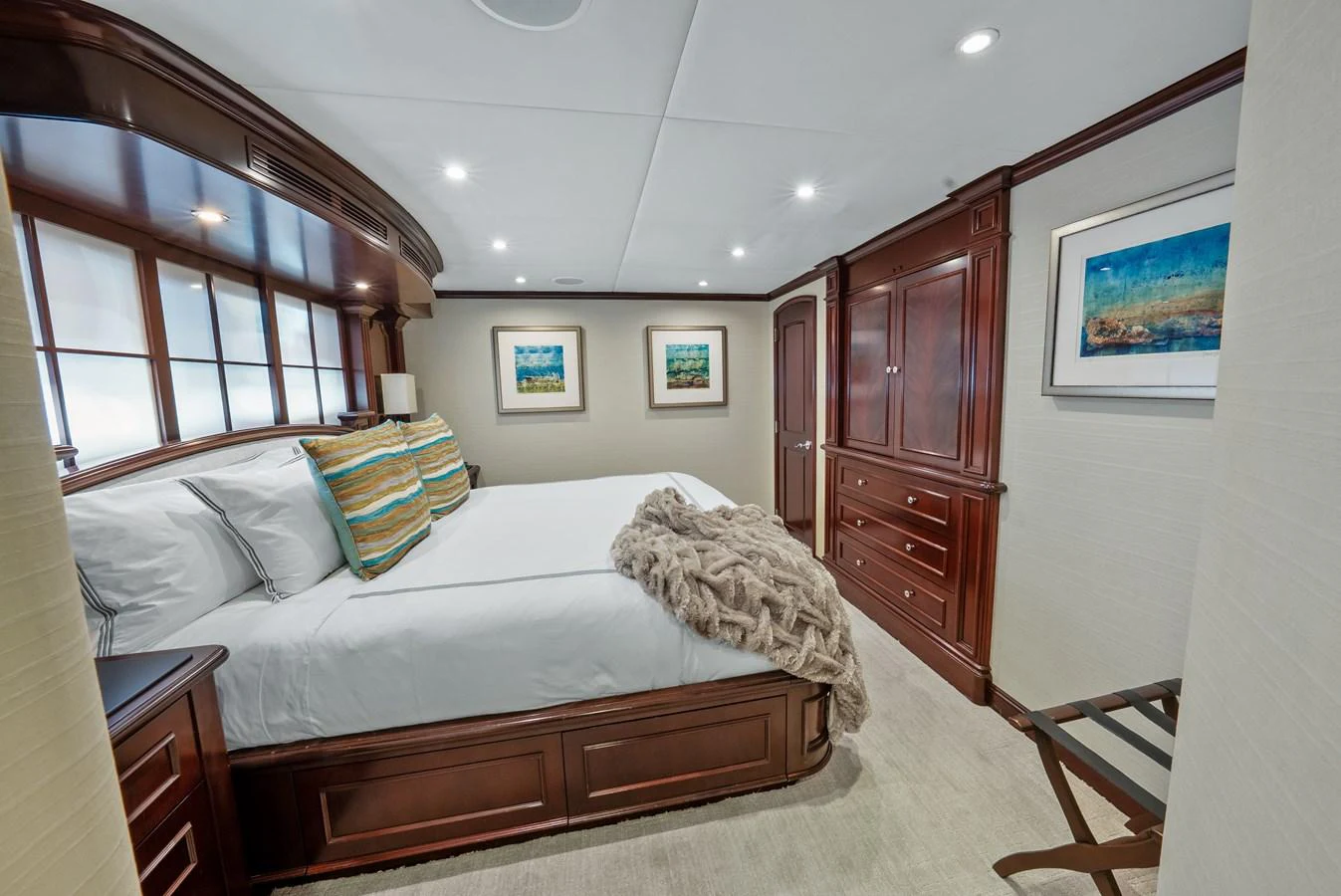 a bedroom with a bed and a dresser aboard NICOLE EVELYN Yacht for Sale