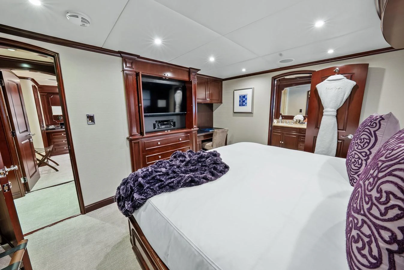 a bedroom with a bed and a mirror aboard NICOLE EVELYN Yacht for Sale