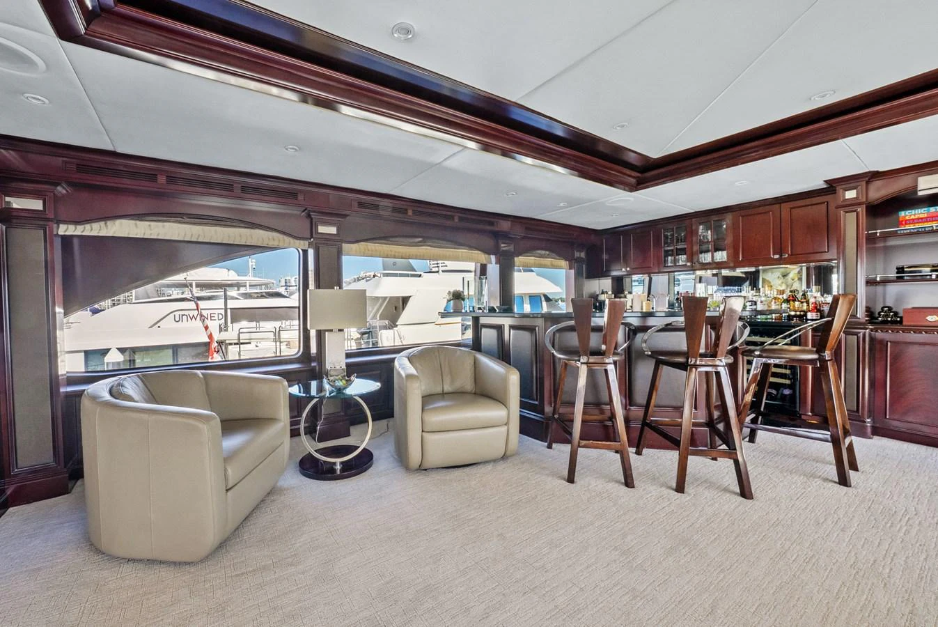 a living room with a couch and chairs aboard NICOLE EVELYN Yacht for Sale