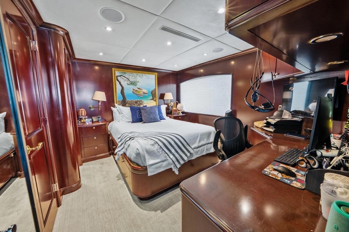 a bedroom with a bed and desk aboard NICOLE EVELYN Yacht for Sale