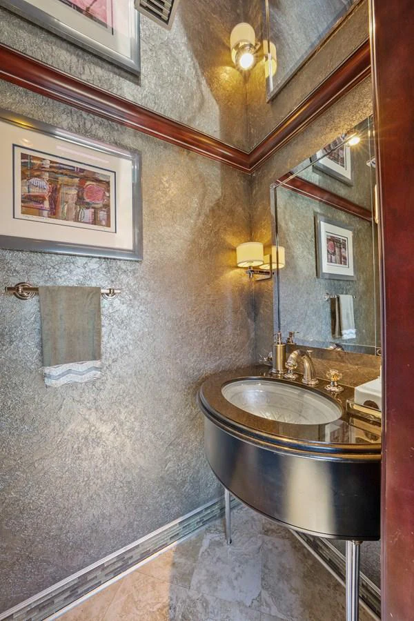 a bathroom with a sink and a mirror aboard NICOLE EVELYN Yacht for Sale