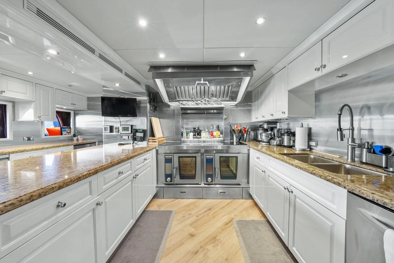a kitchen with white cabinets aboard NICOLE EVELYN Yacht for Sale