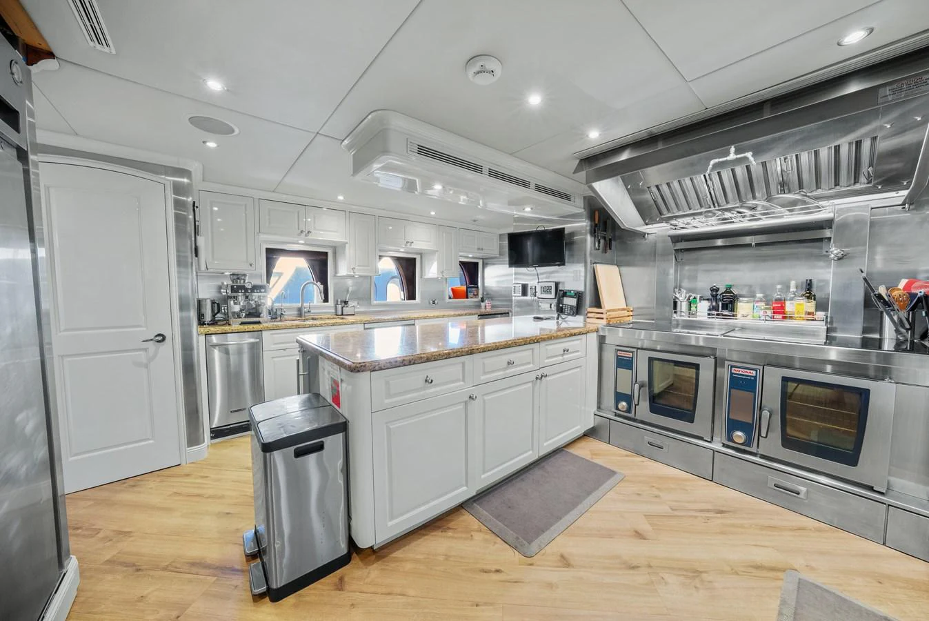 a kitchen with a large island aboard NICOLE EVELYN Yacht for Sale