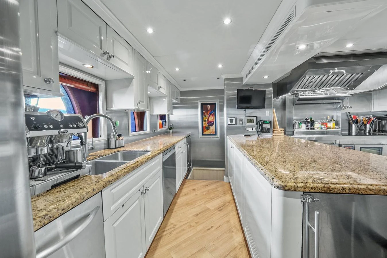 a kitchen with a countertop sink and cabinets aboard NICOLE EVELYN Yacht for Sale