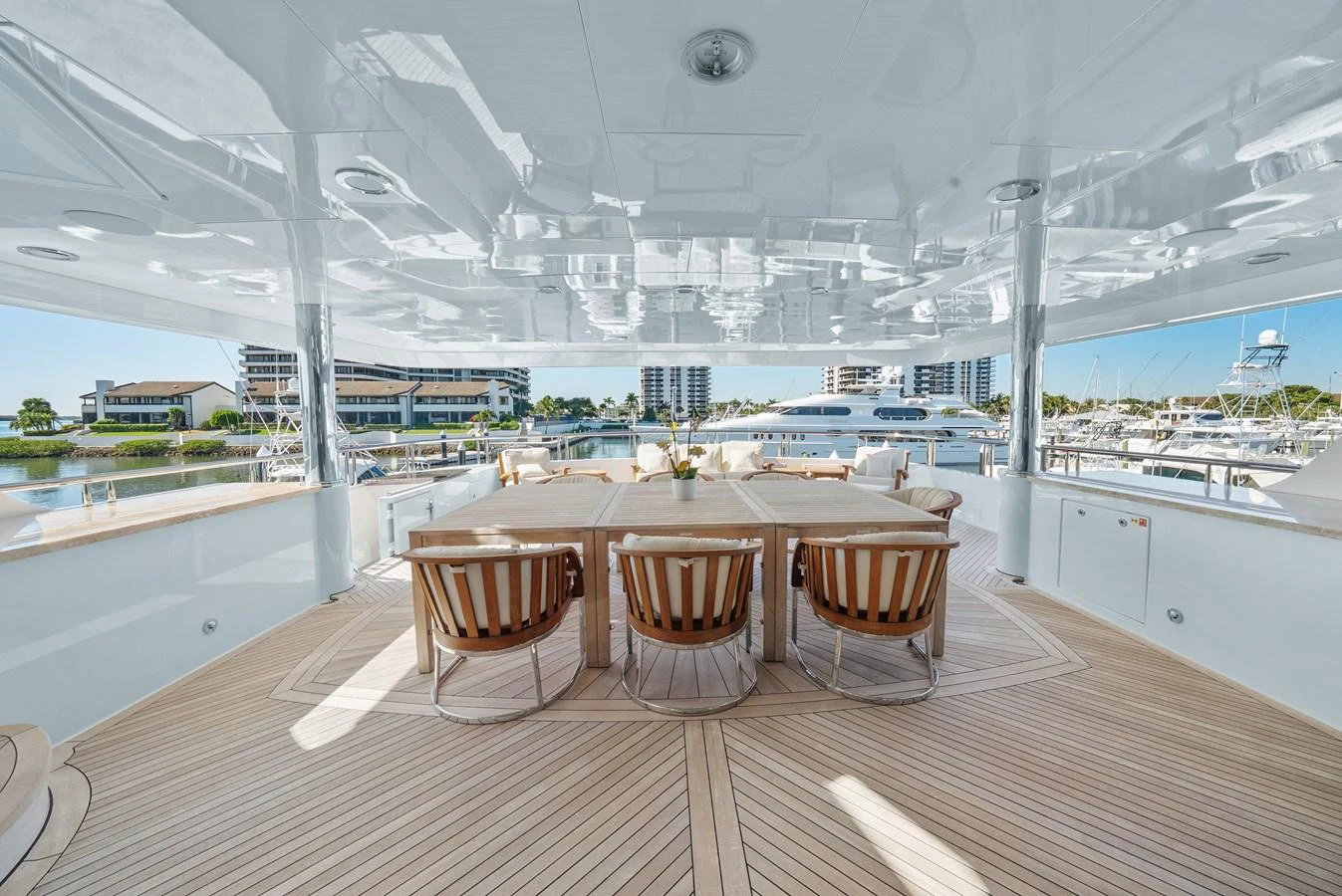 a table and chairs on a deck aboard NICOLE EVELYN Yacht for Sale
