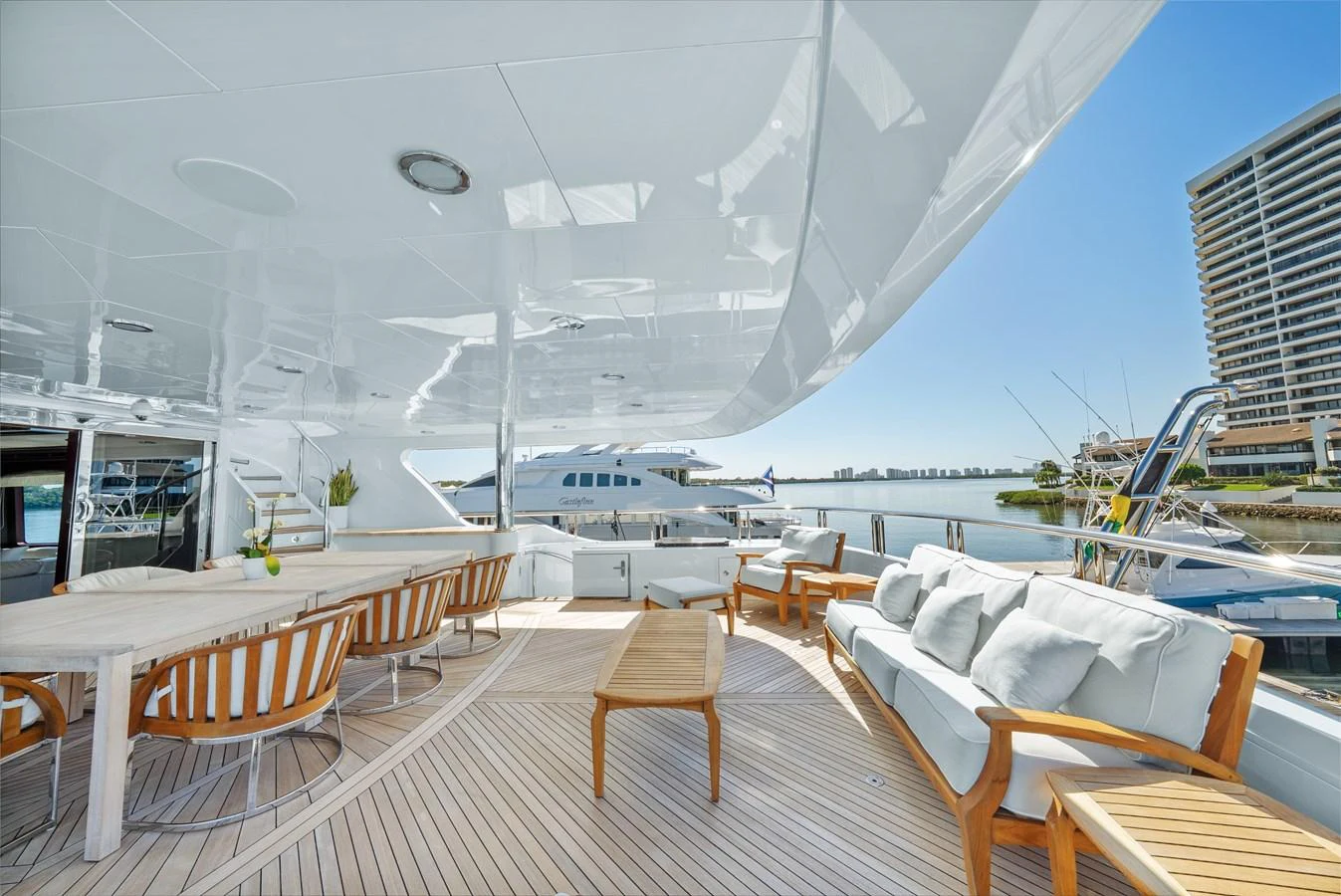 a deck with tables and chairs on it aboard NICOLE EVELYN Yacht for Sale