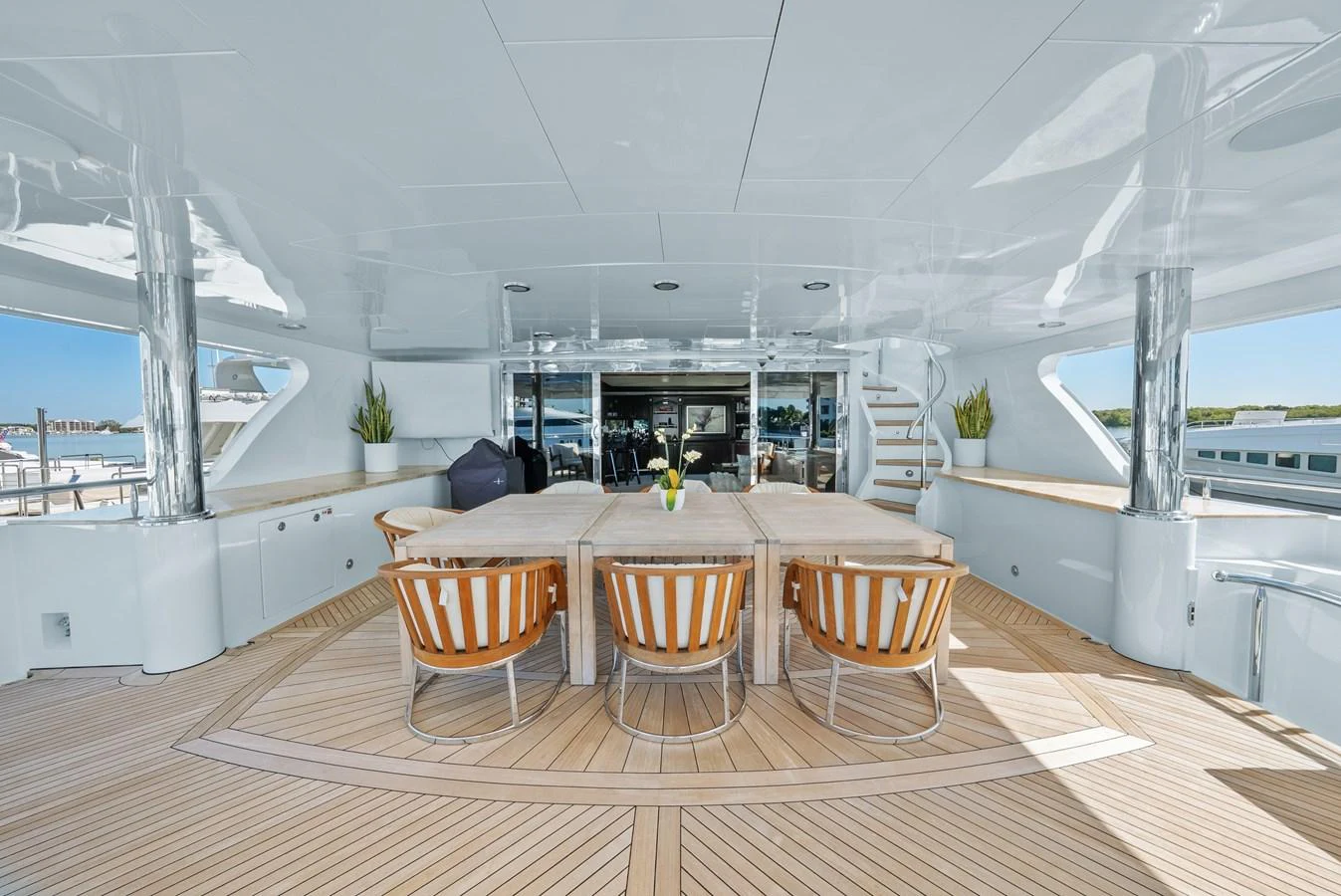 a room with a table and chairs aboard NICOLE EVELYN Yacht for Sale