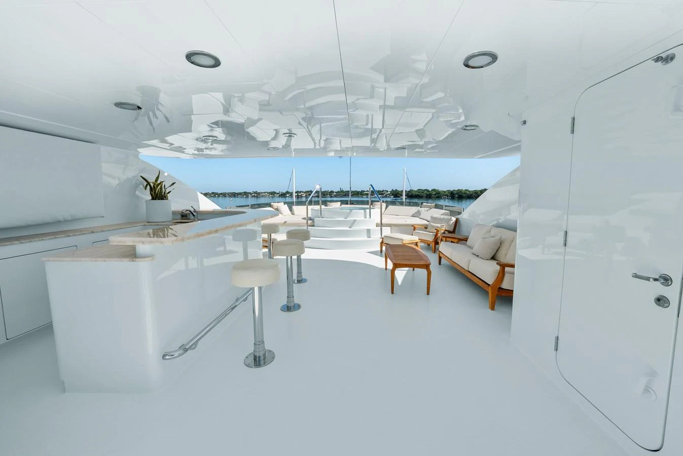 a room with white walls and a table and chairs aboard NICOLE EVELYN Yacht for Sale