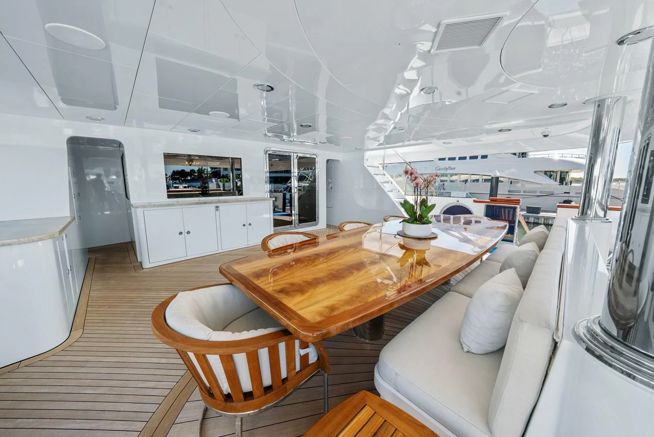 a large white kitchen with a dining table and chairs aboard NICOLE EVELYN Yacht for Sale