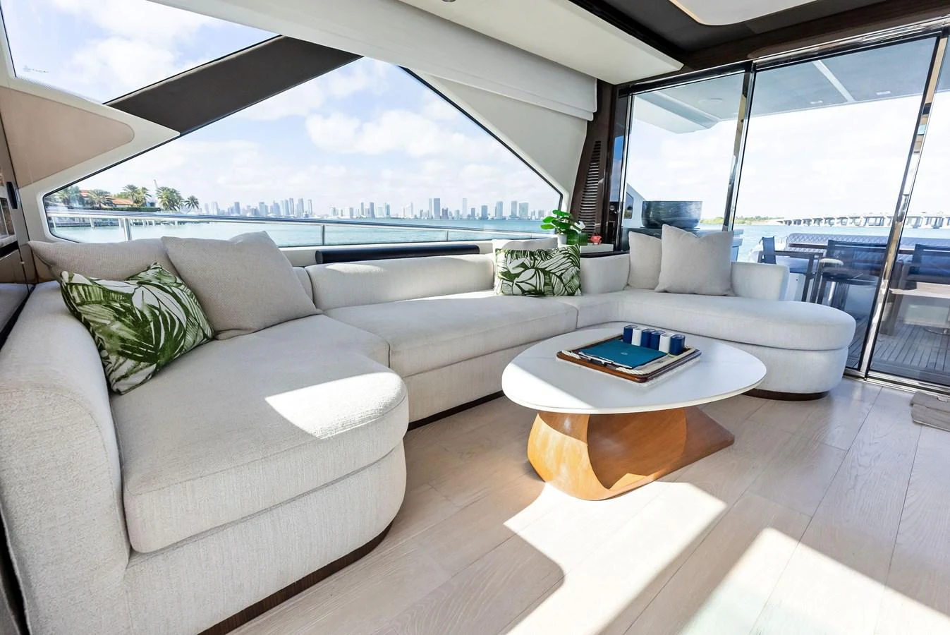 The salon features a spacious and comfortable seating area with large windows offering stunning views. aboard PANDA Yacht for Sale