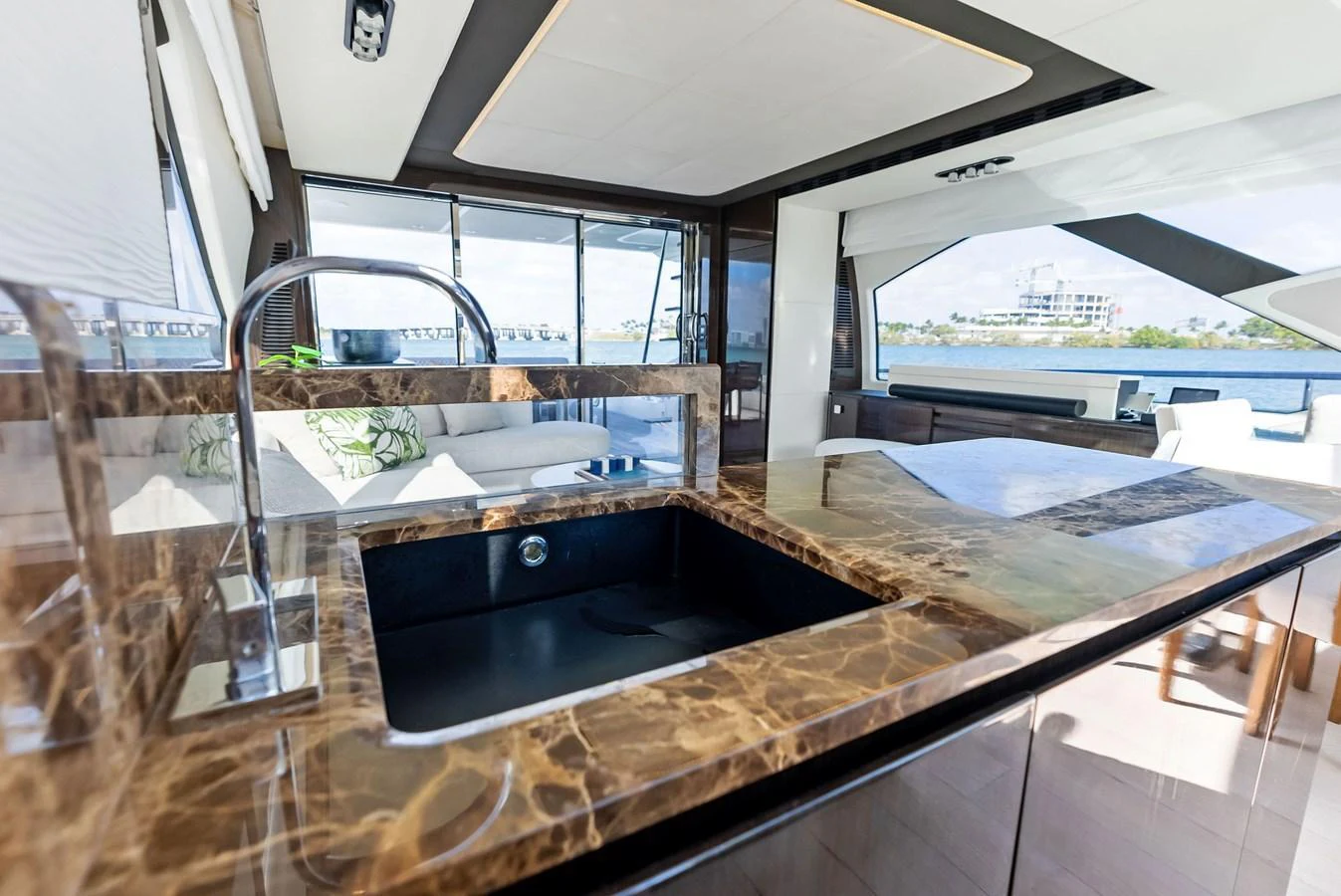 The yacht's galley features a luxurious marble countertop with a modern sink and ample natural light. aboard PANDA Yacht for Sale