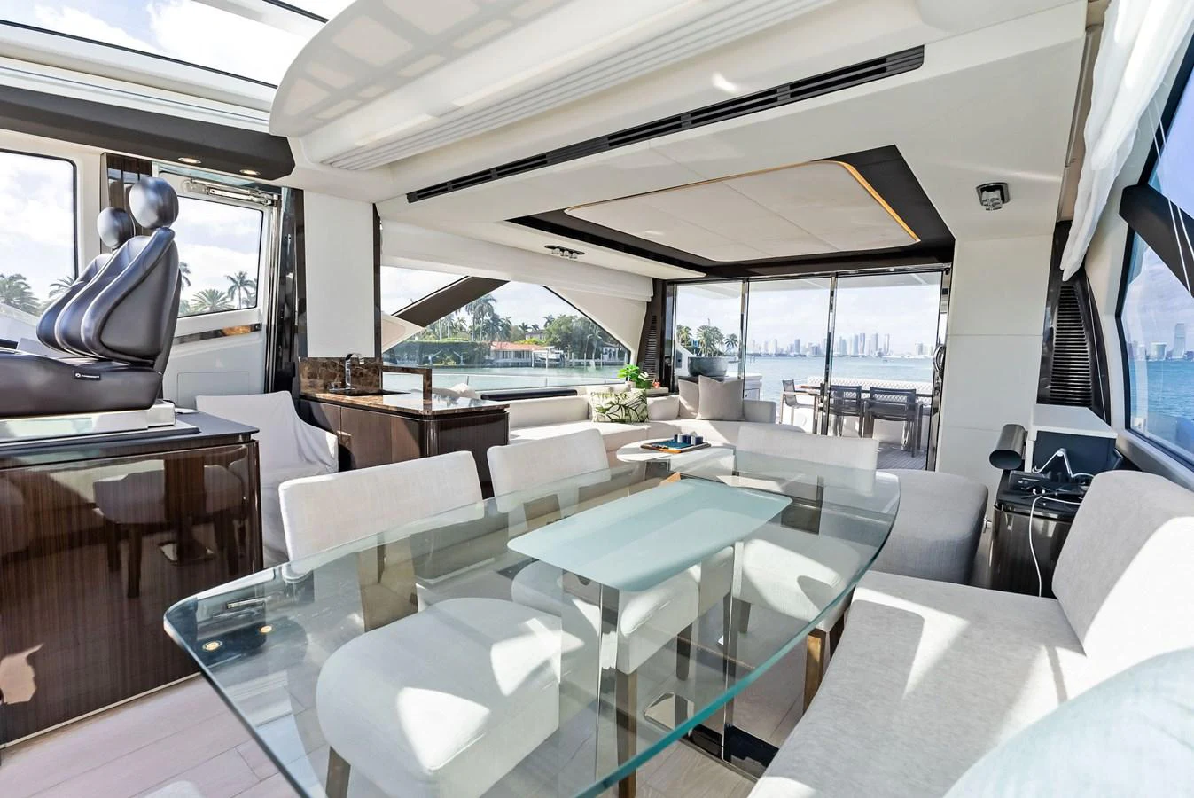 The salon offers a spacious and luxurious setting with ample natural light and modern furnishings. aboard PANDA Yacht for Sale