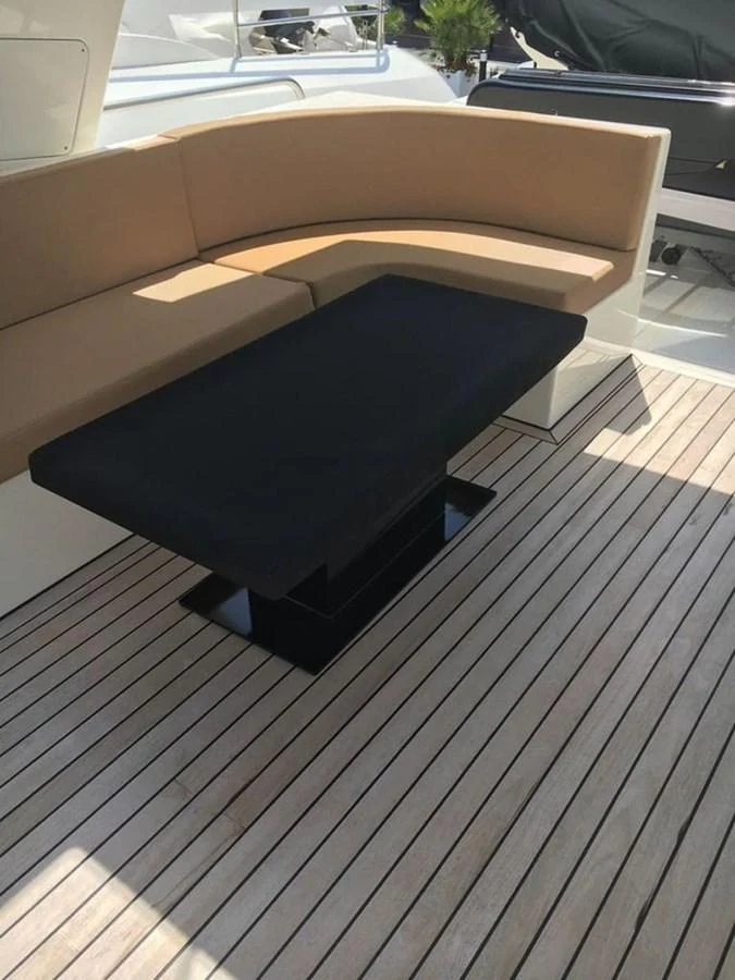 a black couch on a deck aboard YAIZA Yacht for Sale