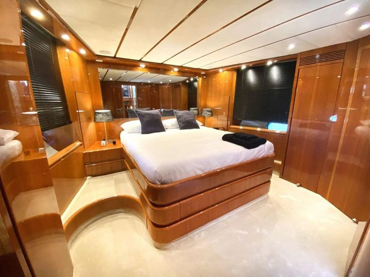 a room with a bed and a large mirror aboard YAIZA Yacht for Sale