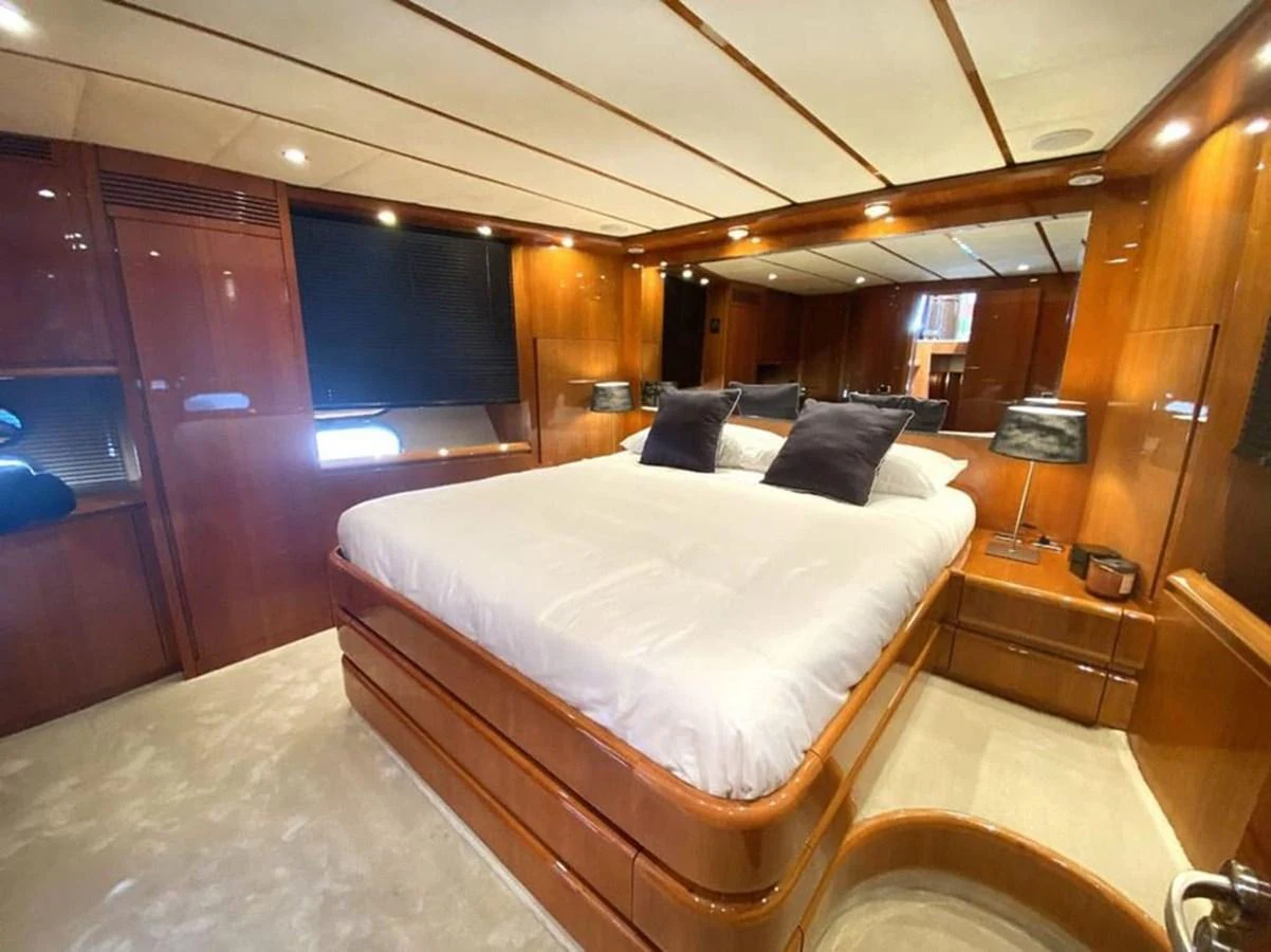 a room with a bed and a desk aboard YAIZA Yacht for Sale