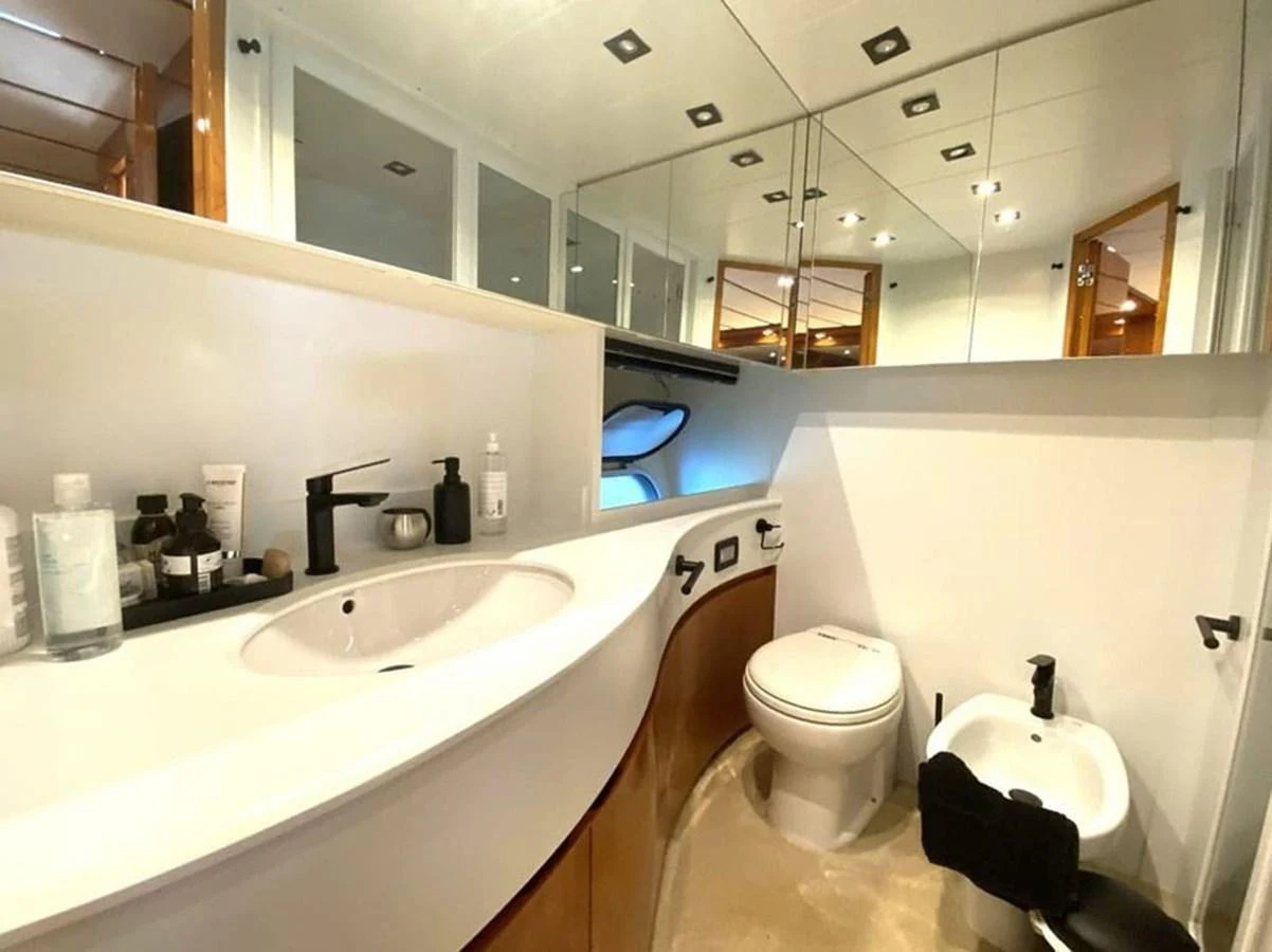 a bathroom with a sink toilet and a mirror aboard YAIZA Yacht for Sale