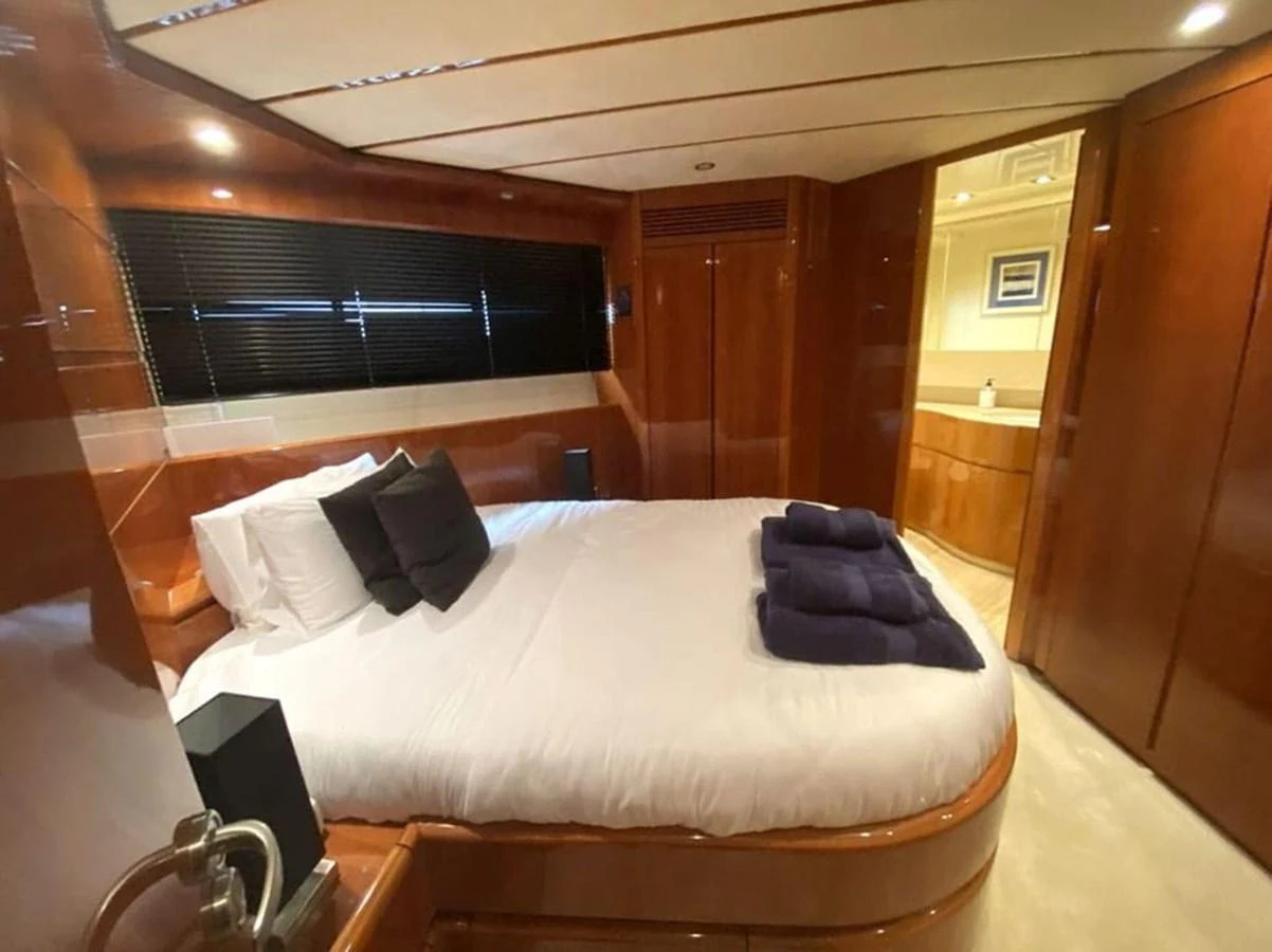 a bed with a white sheet and pillows on it aboard YAIZA Yacht for Sale