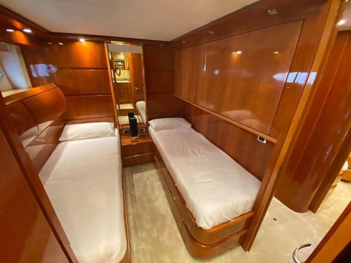 a room with a bed and a mirror aboard YAIZA Yacht for Sale