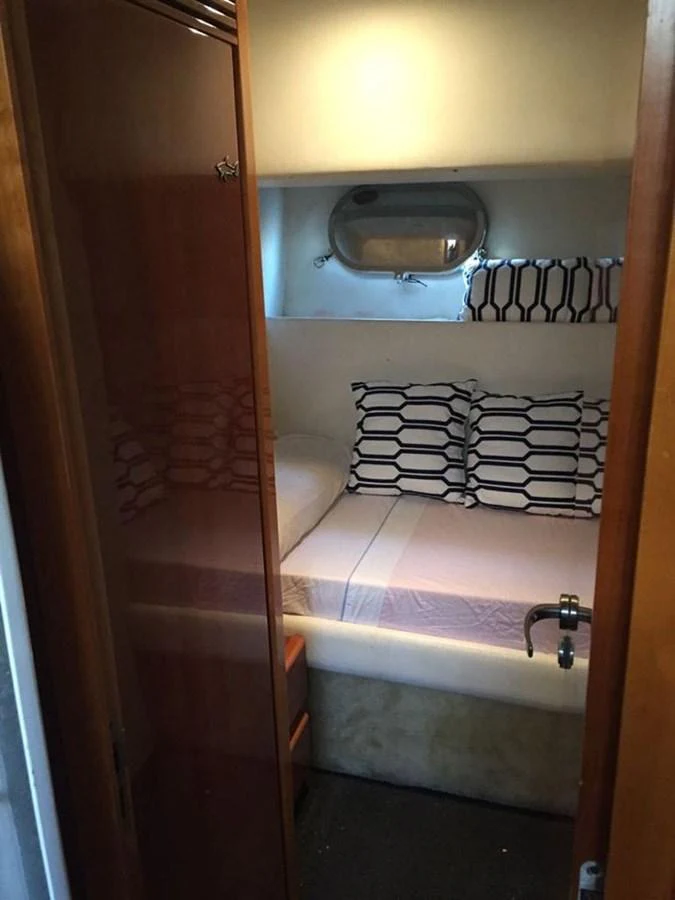 a small bathroom with a sink and a bed aboard YAIZA Yacht for Sale