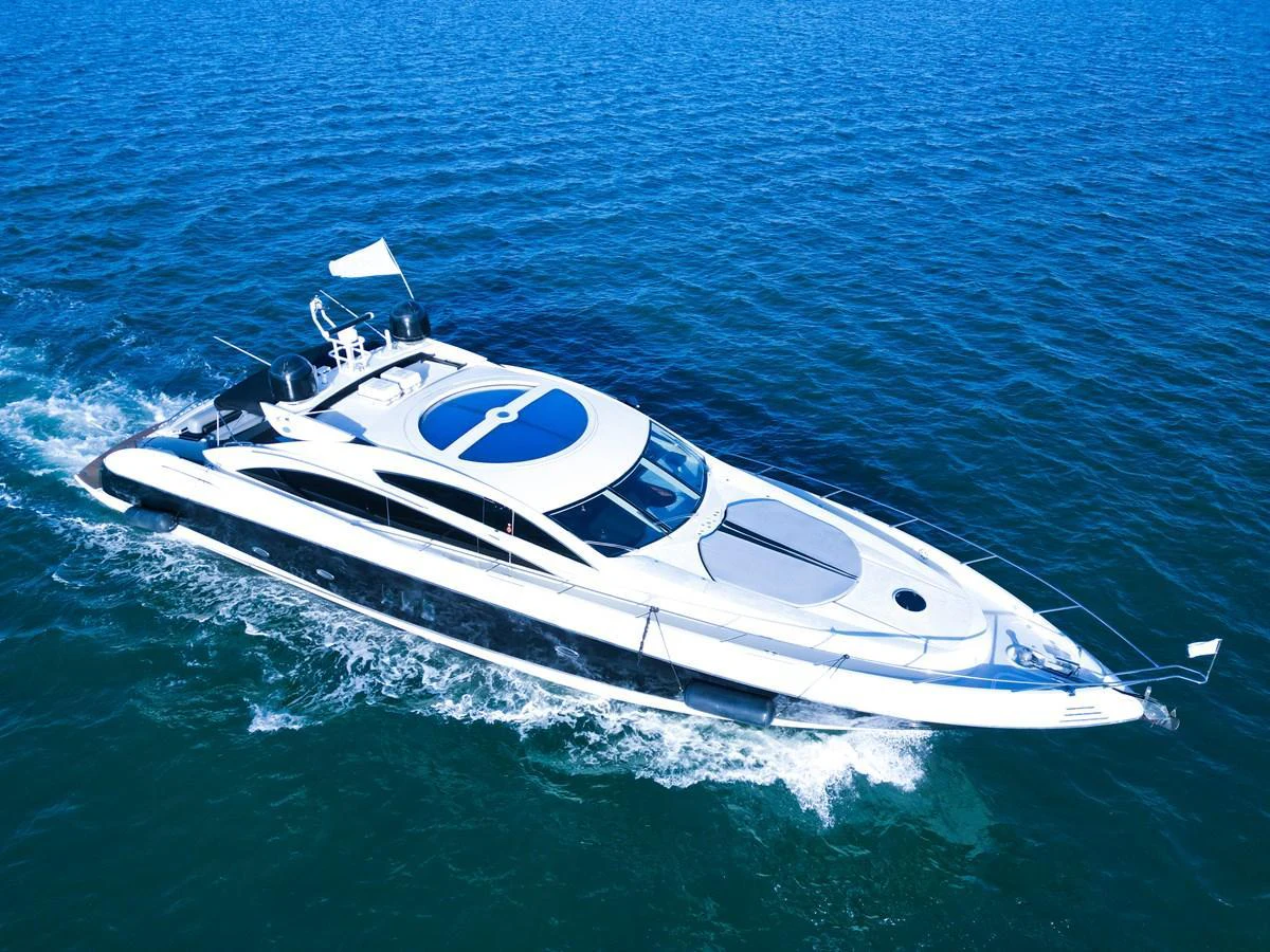 A sleek and modern yacht glides effortlessly through the open water. aboard THE GAMBLER Yacht for Sale