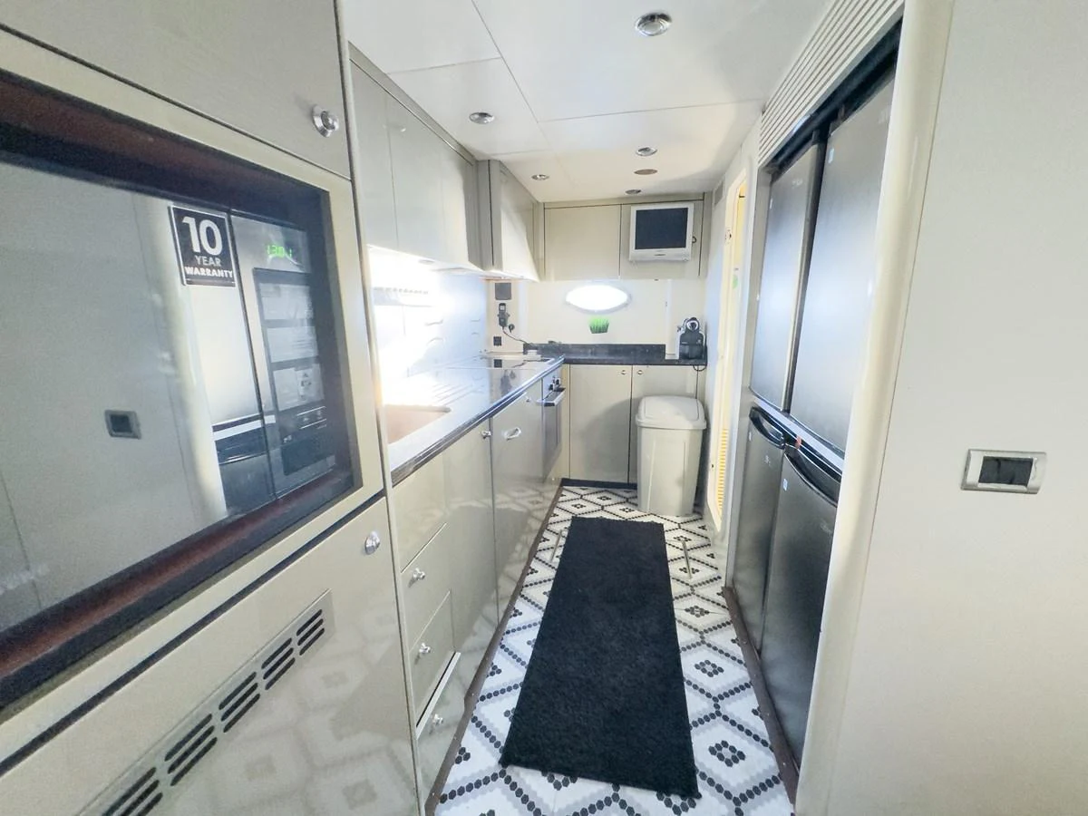 A sleek and modern galley with ample storage and high-end appliances. aboard THE GAMBLER Yacht for Sale