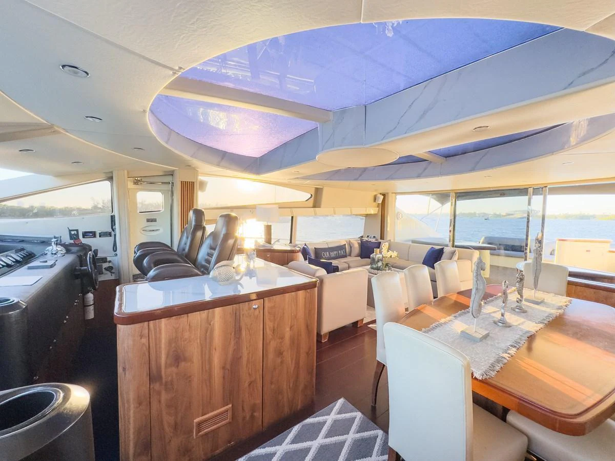 The salon features luxurious seating, a dining area, and large windows offering panoramic views. aboard THE GAMBLER Yacht for Sale