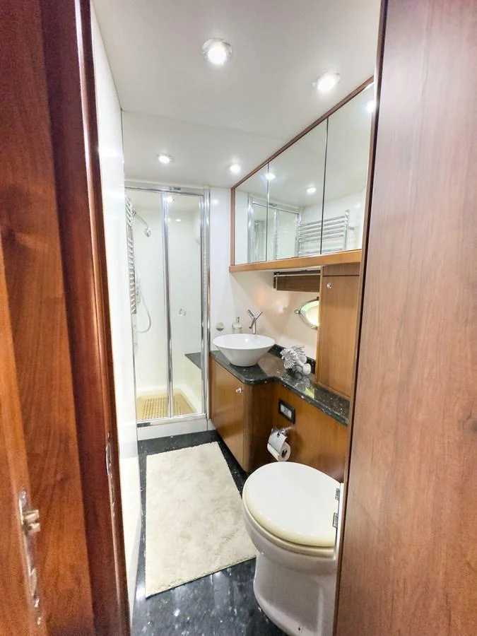 The yacht's bathroom features a sleek design with modern fixtures and ample lighting. aboard THE GAMBLER Yacht for Sale