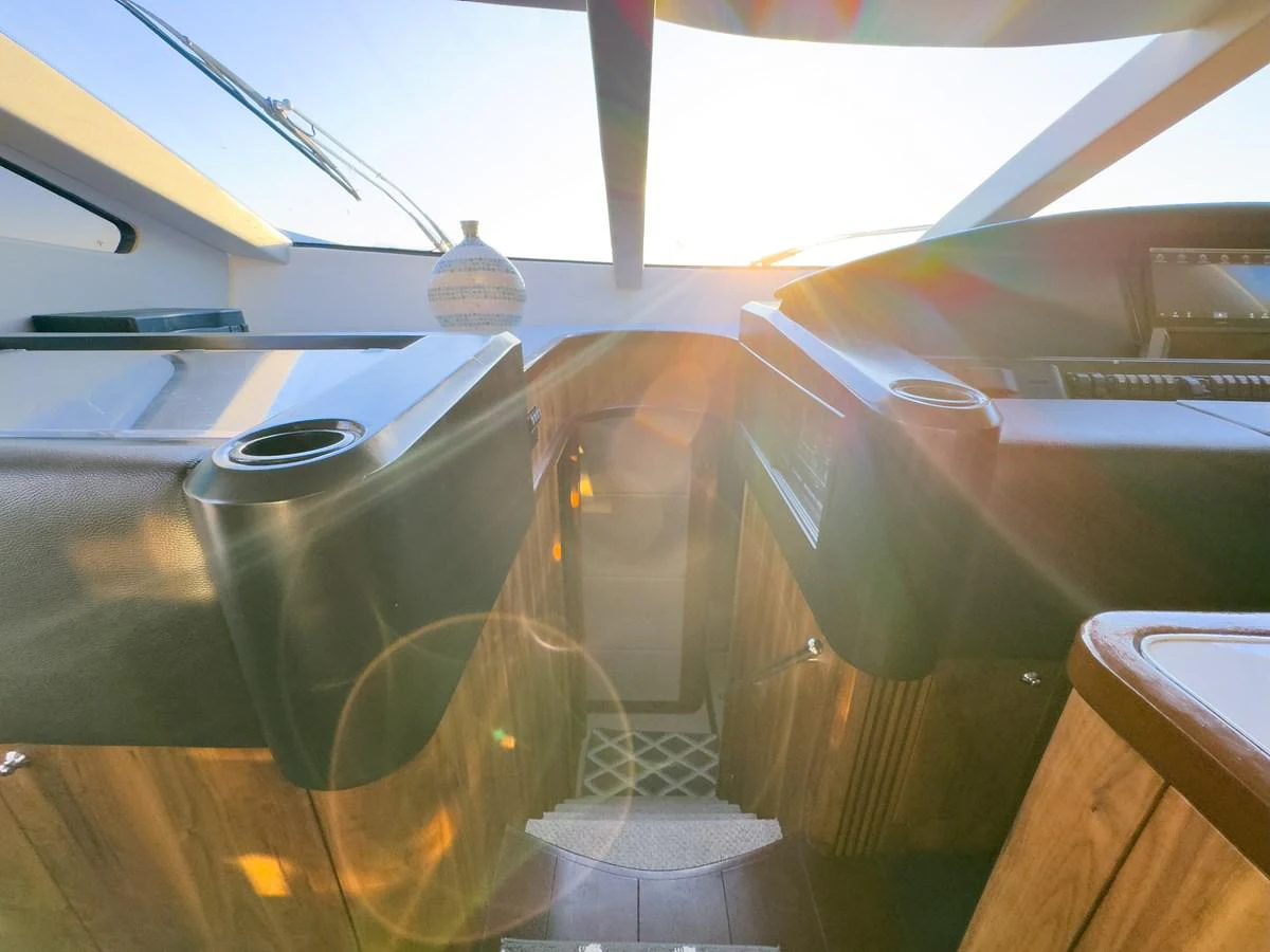 A cozy interior space with wooden accents and modern design elements, illuminated by natural light. aboard THE GAMBLER Yacht for Sale