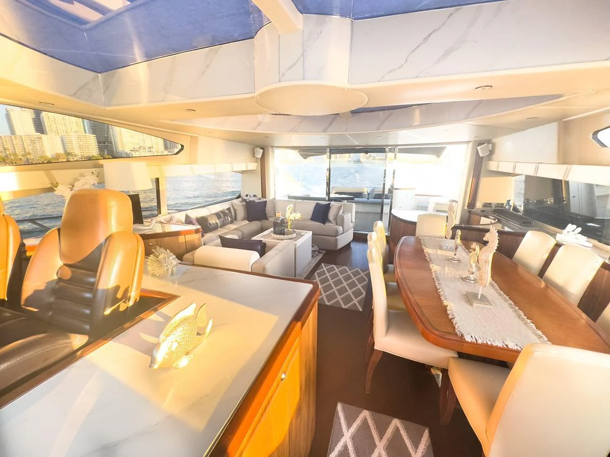 The yacht's salon features luxurious seating, a dining area, and large windows offering panoramic views. aboard THE GAMBLER Yacht for Sale