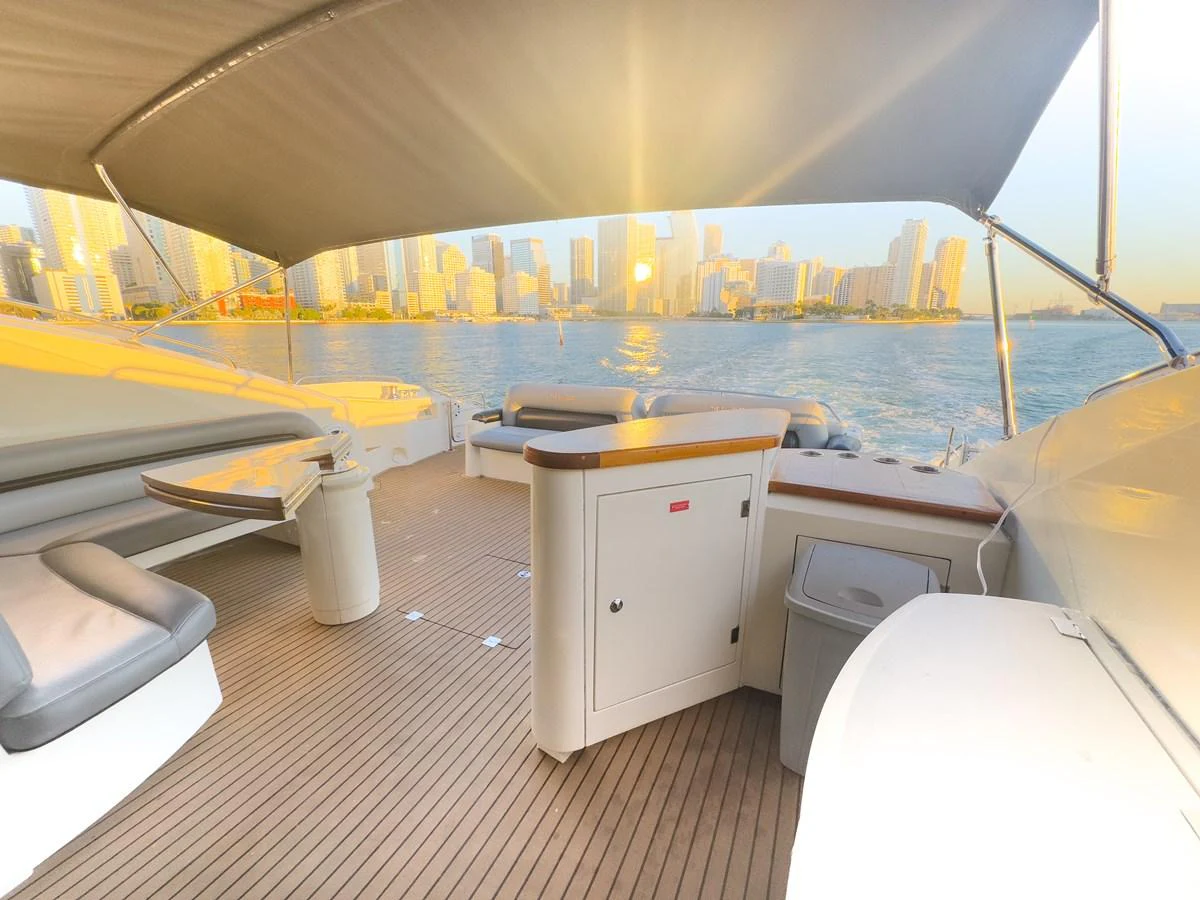 The aft deck offers a spacious and inviting area with comfortable seating and stunning city skyline views. aboard THE GAMBLER Yacht for Sale